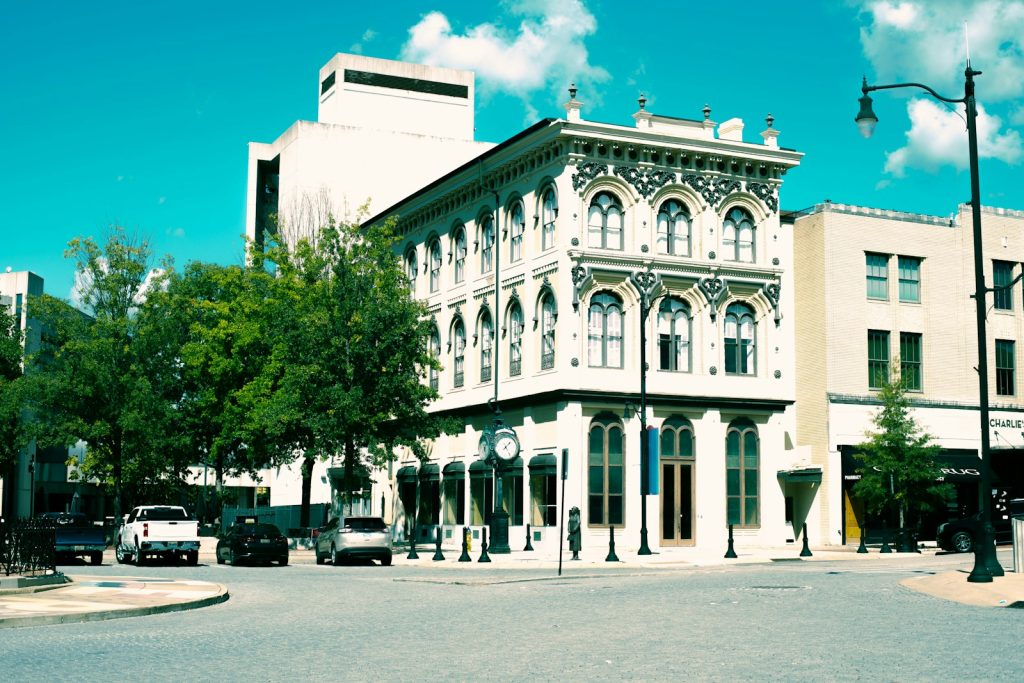 A large white building sitting on the corner of a street